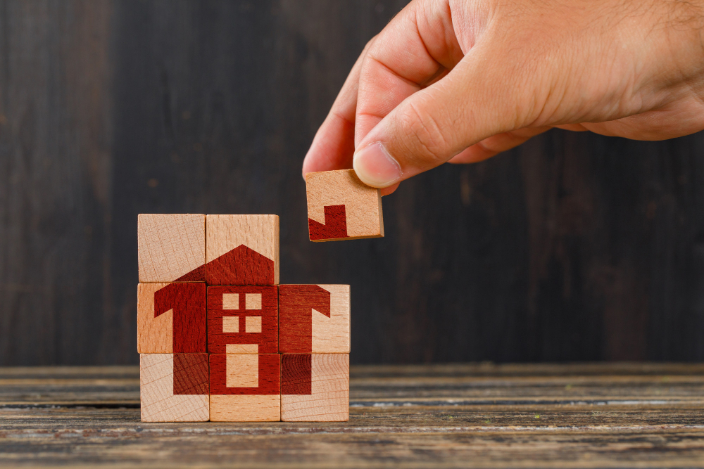 stay-at-home-concept-on-wooden-table-side-view-hand-holding-wooden-cube